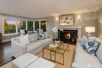 Formal Living room with fireplace and views to the east of the Cascade mountains and peek a bo view of Lake Washintong.