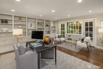 Main floor den/office.  Doors out to the back yard and plenty of great storage for your own library or office.