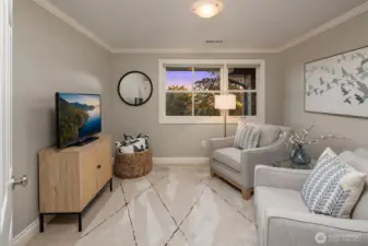 This smaller, view bedroom is currently staged as a den.  This is the closest bedroom to the primary suite and has a closet.