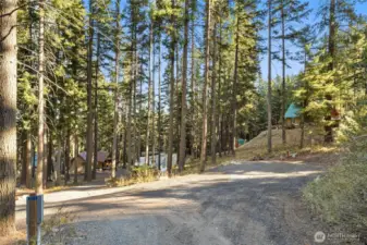 There's a level RV space at the top of the driveway with power and water hookup. Large enough for 2 RVs.