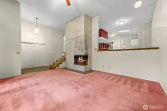 Opposite view of the living room looking up to the second floor living area and the stairs to the basement.