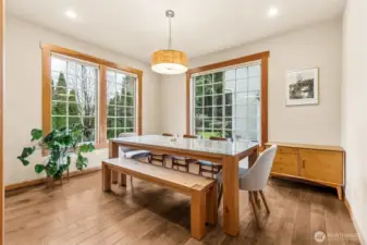 This dining room shows up bright and ready, with oversized windows pulling in sunlight all day and those thick maple hardwood floors continuing to impress. The drum style chandelier keeps it current without being flashy, and the proportions here give you options. Set it up for dinners, holidays, and hosting, or pivot it into a den, library, or second living space if that fits your life better. The seller is also offering to leave the dining bench, which is one less thing to shop for and honestly a great anchor piece for the room.