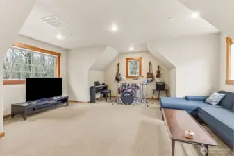 Zoomed in on the action zone, you’ve got a legit TV lounge paired with space for music, gaming, or whatever hobby takes over next. The oversized windows keep it bright all day, and the extra accent windows add a little architectural interest that makes the room feel more custom than cookie cutter. Wood wrapped trim ties it back to the rest of the house, and with 3200 square feet overall, it’s clear this home didn’t skip on giving you room to actually live.