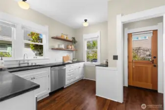 Updated kitchen with custom cabinetry and stainless steel appliances.