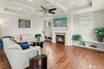 architectural details include boxed ceiling, hardwood floors, built-in shelves