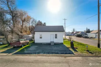 Multiple outbuildings for extra storage, a corner lot, and alley access enhance the property's appeal.