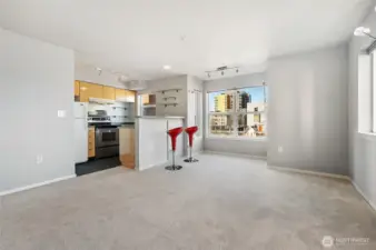 Bright and open living room and dining area with Space Needle View from Kitchen, Living room and Deck.