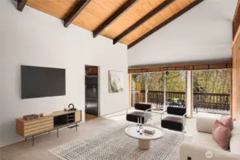 Soaring beamed ceilings create a sense of grandeur, while a dramatic wall of windows floods the space with natural light and offers breathtaking views of the expansive, lush park.