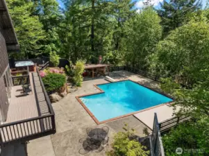 The oversized sliding door seamlessly connects indoor and outdoor living, opening to a spacious deck that overlooks your private oasis, perfect for relaxing or entertaining.