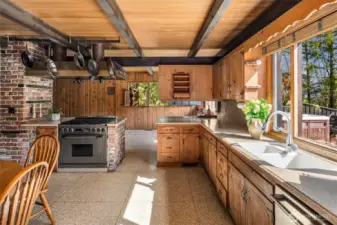 The kitchen is bathed in natural light, seamlessly flowing into the living space and featuring elegant terrazzo floors for a stylish and timeless touch.