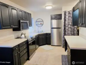 Kitchen of 6601, stainless steel appliances with top of the line glass stop Samsung stove, microwave and dishwasher.