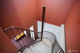 Down the half spiral stairs.