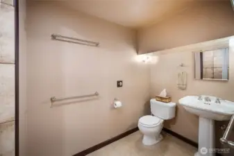 a 3/4 bath with shower is right beyond the kitchenette. There is a large sink right behind the kitchenette wall, which is also quite functional.