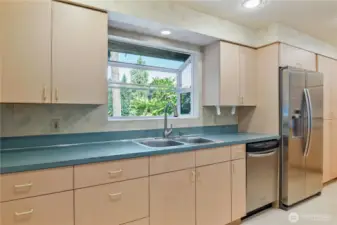 mauve laminate cabinets, beautiful territorial views out kitchen window.