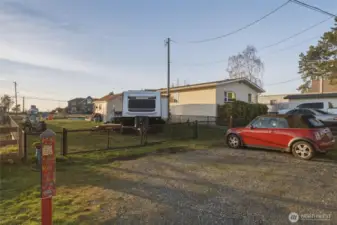 Ample gravel parking outside the fence.