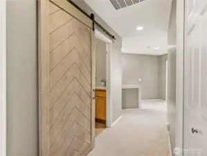 This stunning, oversized chevron-patterned barn door serves as a functional piece of art