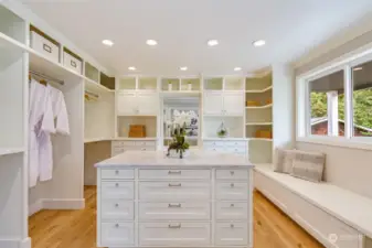 Luxurious walk-in closet complete with vanity, pocket, French doors, and hardwood floors.