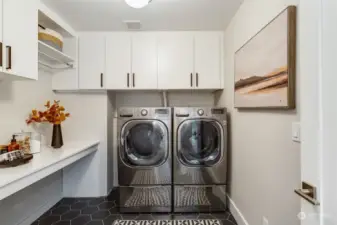 Large laundry room with full-size washer and dryer.