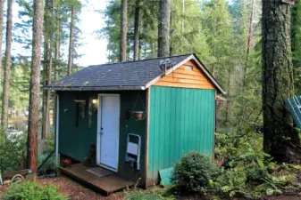 Dual purpose building houses the internet as well as a nice work area complete with bench and shelves.