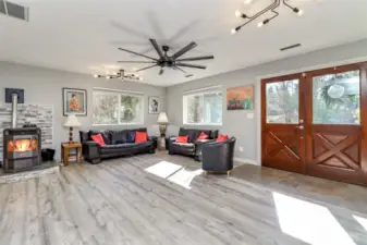 Living room and entry.  Pellet stove with whole house circulation keeping back bedrooms warm for winter comfort.