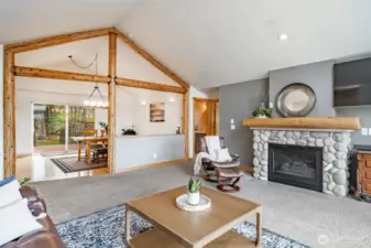 Custom natural gas fireplace and vaulted ceilings in living room area.