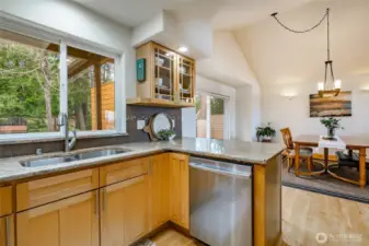 Dishes , no problem ! Nice big window above sink to look out to your beautiful back yard with mature trees and plants that'll bloom beautifully each Spring .