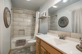 Downstairs full tiled bath .