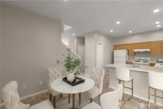 Open-concept kitchen features a pantry and an adjacent breakfast nook—perfect for casual dining !