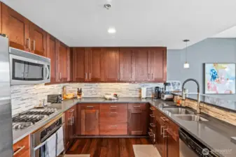 The chef's kitchen has been updated with new countertops and custom tile backsplash. Look at the terrific cabinet space!