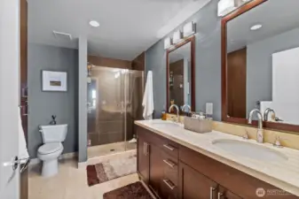 The primary bath features a double vanity with marble counters and floors.