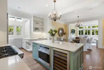 Upscale kitchen ready for the most discerning chef. Dreamy layout with casual eating, island seating, sunny sitting room in the background and abundant windows letting in light all day.