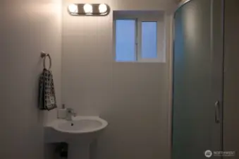 Three quarter bath on the main level. Staging is removed