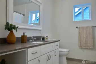 Full bath upstairs with quartz countertops. Staging is removed.