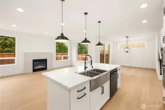 The great room offers generous natural light, a sleek gas fireplace framed by stone surround, and views of the fenced backyard. The open-concept layout connects seamlessly to the kitchen and dining areas, creating a flexible and inviting space for gatherings or quiet evenings. Wide-plank flooring enhances the bright, modern feel throughout.    These photos are from Lot 3 at Gooden Hollow, which is the same floorplan. However, Lot 6 will have changes, so all photos, renderings, site maps, and floorplans are for visualization purposes only. Plans, colors, building orientation, finishes, home outlook, and other details can and WILL vary.