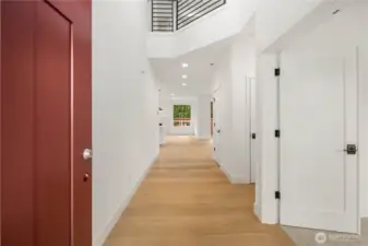 The spacious entry hallway welcomes you with tall ceilings, crisp white millwork, and a clear sightline toward the main living spaces for an immediate sense of openness. Durable engineered hardwood floors extend through the main level, offering both style and everyday convenience.    These photos are from Lot 3 at Gooden Hollow, which is the same floorplan. However, Lot 6 will have changes, so all photos, renderings, site maps, and floorplans are for visualization purposes only. Plans, colors, building orientation, finishes, home outlook, and other details can and WILL vary.