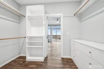 Master walk-through closet leading to private bathroom