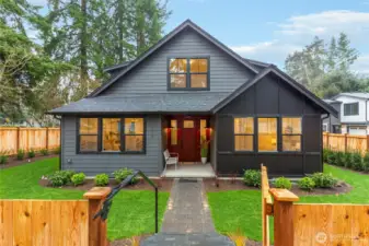 A Paved walkway, complemented by a railing, leads to the front entry.