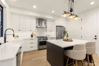 Quartz countertops along the kitchen and center island for a quality finish.