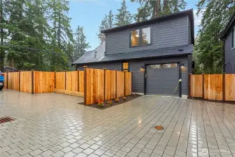 Garage with a dedicated parking pad to the right of it.