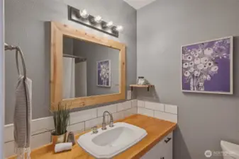 Full Guest bathroom with tub surround.
