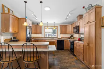 Kitchen has ample storage in the beautiful Hickory cabinetry.