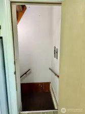Landing at the top of the stairs from garage & shop space that lead  to the kitchen and the home's wonderful living areas