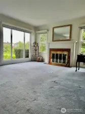 View of the living room with a wood burning fireplace to make sure you have warm and cozy nights.