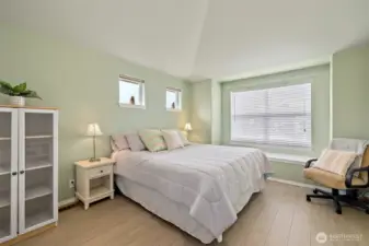 Spacious primary bedroom with window seating/storage.   .