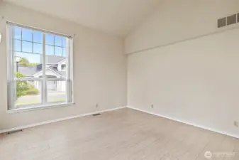 Enter the spacious living room with expansive windows that fill the room with natural light.
