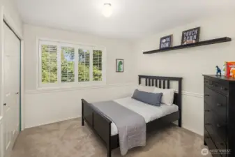 One of two secondary bedrooms, with plantation shutters, walk-in California Closets