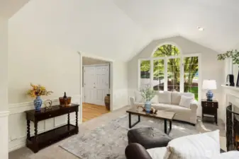 Vaulted ceilings and a gorgeous window overlooking mature landscaping make this room so very special. It's filled with sunlight and a wonderful place to relax or entertain.