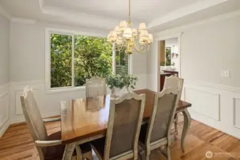 Wainscotting, and tray ceilings,& refinished hardwood floors, make the dining room a practical everyday space, but also fancy enough for hosting on high days and holidays.
