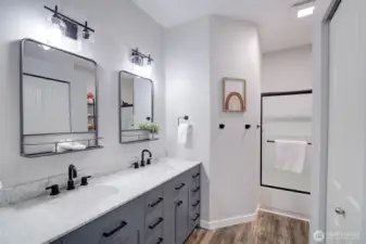 Main bath in upstairs hallway has plenty of drawers and linen closet.