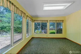 Sunroom in back is a great place to relax and enjoy your back yard